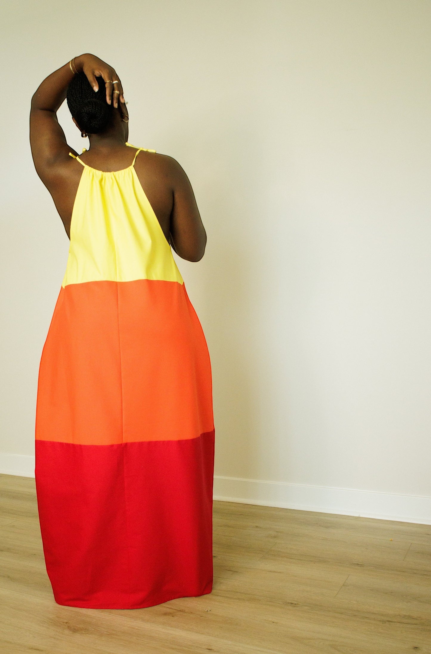 Shop Talaya tri-color maxi dress in yellow, orange, and red cotton sateen with self-tie straps. Bold, unlined design.
